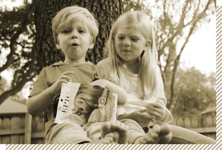 Two children eating an Epic Provisions Performance Bar